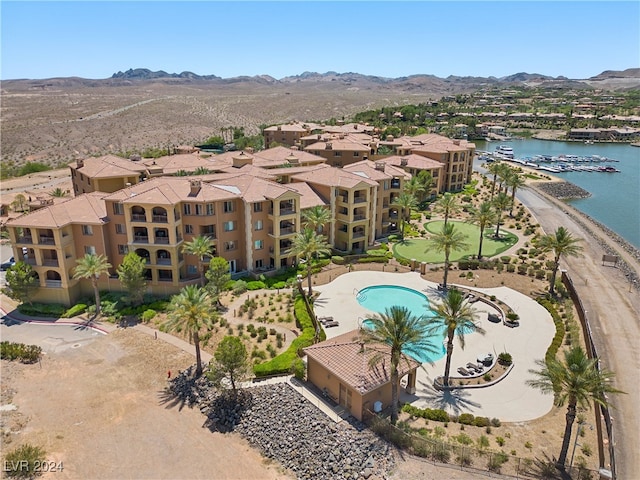 drone / aerial view featuring a water and mountain view