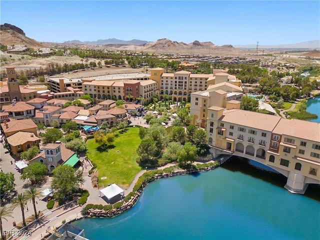 drone / aerial view featuring a water and mountain view