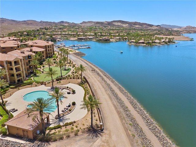 drone / aerial view featuring a beach view and a water and mountain view