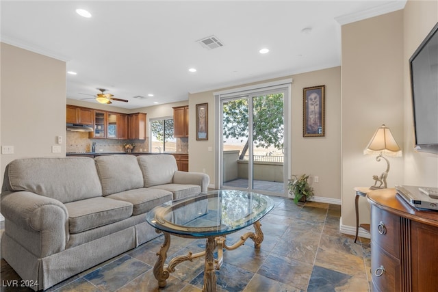 living room with ceiling fan and crown molding