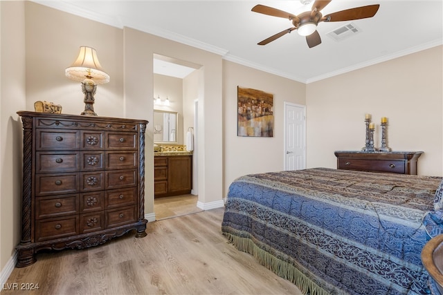 bedroom featuring ceiling fan, ornamental molding, light hardwood / wood-style flooring, and ensuite bath