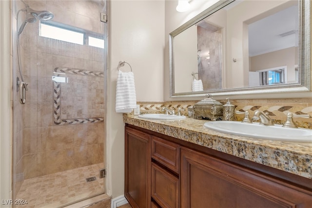 bathroom with vanity, backsplash, and a shower with door