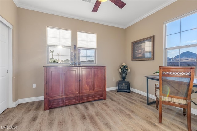 living area with ceiling fan, crown molding, a mountain view, and light hardwood / wood-style floors