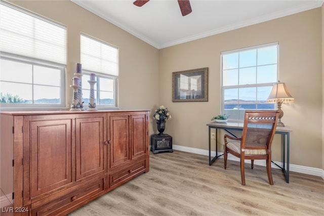 office space featuring ceiling fan, a mountain view, crown molding, and light hardwood / wood-style floors