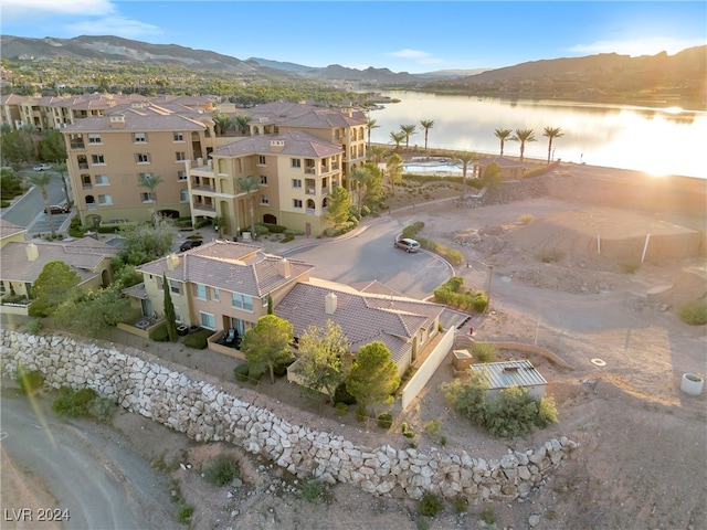 drone / aerial view featuring a water and mountain view