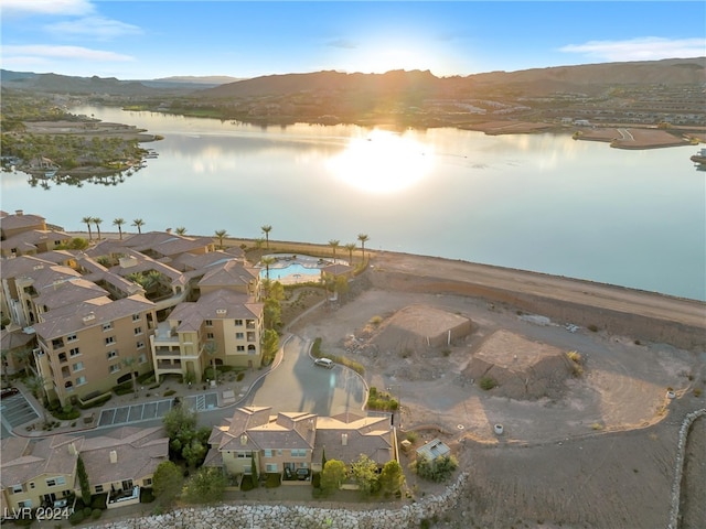 drone / aerial view featuring a water and mountain view