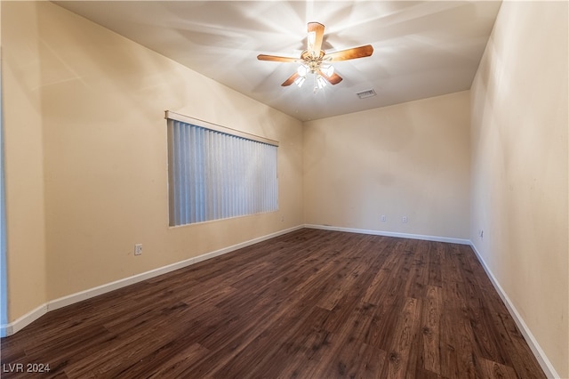 unfurnished room with dark hardwood / wood-style flooring and ceiling fan