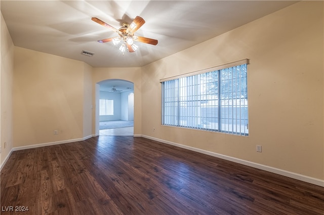 spare room with ceiling fan and dark hardwood / wood-style floors