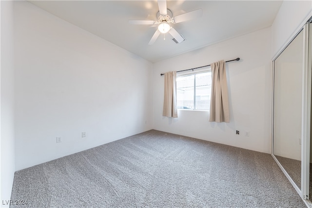 unfurnished bedroom with ceiling fan, a closet, and carpet flooring