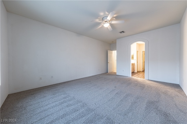 empty room featuring ceiling fan and light colored carpet