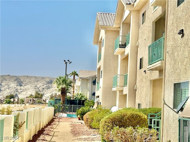 view of property featuring a community pool and a mountain view