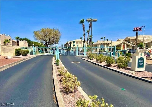 3550 Bay Sands Dr Unit 2082, Laughlin, NV 89029 - view of asphalt road featuring a residential view, a gate, curbs, and a gated entry