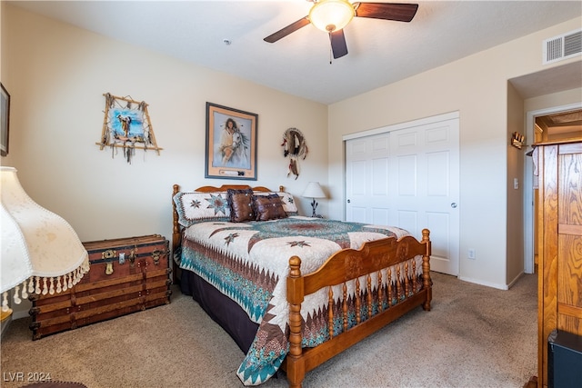 bedroom featuring a closet, ceiling fan, and light colored carpet