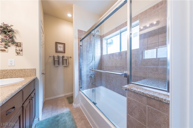 bathroom featuring vanity, enclosed tub / shower combo, and tile patterned flooring