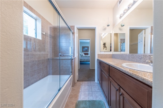 bathroom featuring vanity, bath / shower combo with glass door, and tile patterned floors