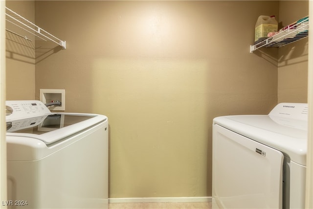 clothes washing area with washer and clothes dryer