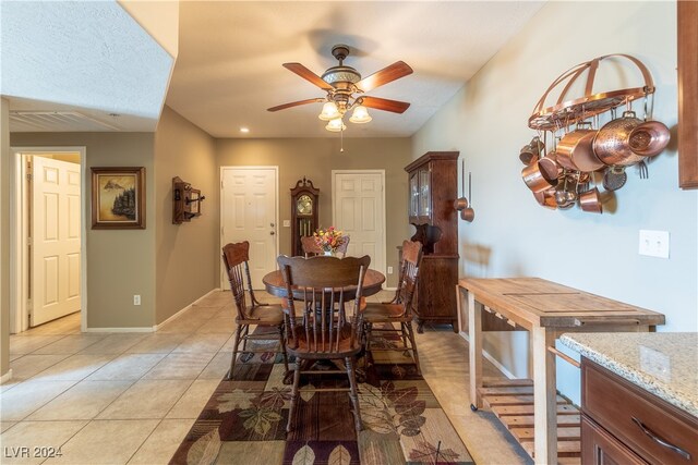 dining area featuring ceiling fan and light tile patterned floors