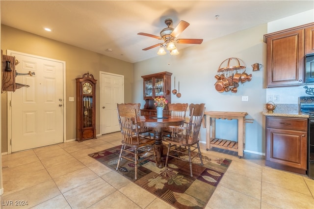 dining space with light tile patterned floors and ceiling fan