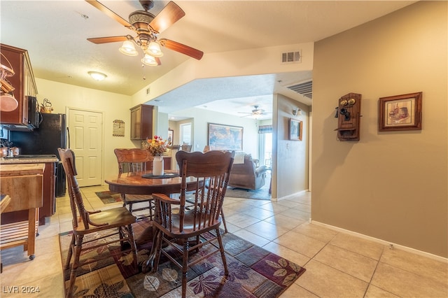 dining space featuring light tile patterned flooring, a textured ceiling, and ceiling fan