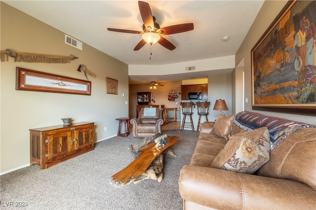 carpeted living room with ceiling fan