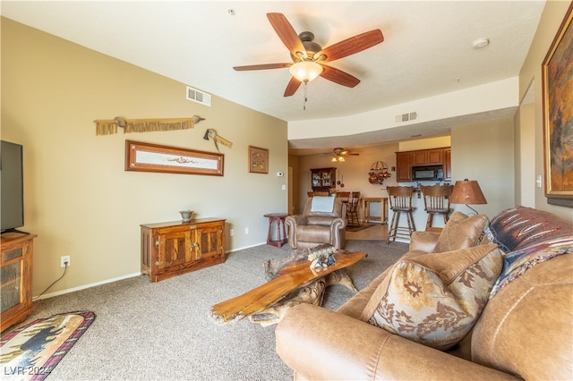 carpeted living room with ceiling fan