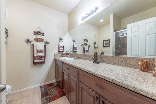 bathroom with vanity, toilet, tile patterned floors, and an enclosed shower