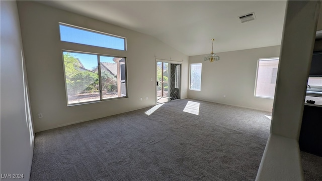 carpeted empty room featuring vaulted ceiling