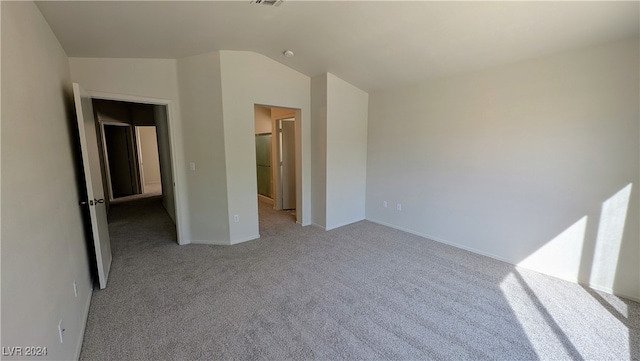 unfurnished bedroom with light carpet and vaulted ceiling