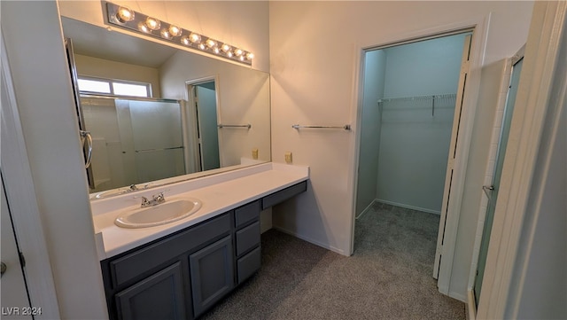 bathroom featuring vanity and a shower with shower door