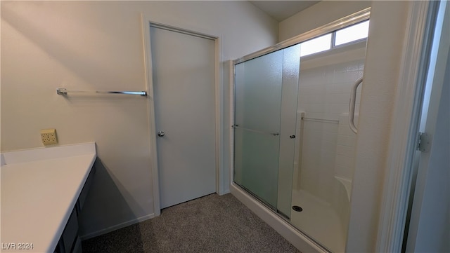 bathroom featuring vanity and a shower with shower door