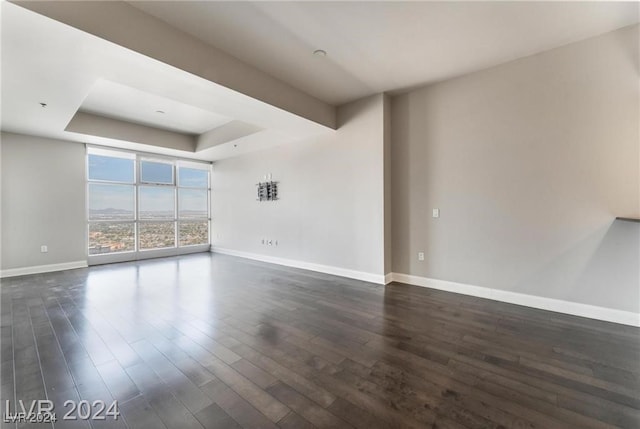 unfurnished room featuring dark hardwood / wood-style floors