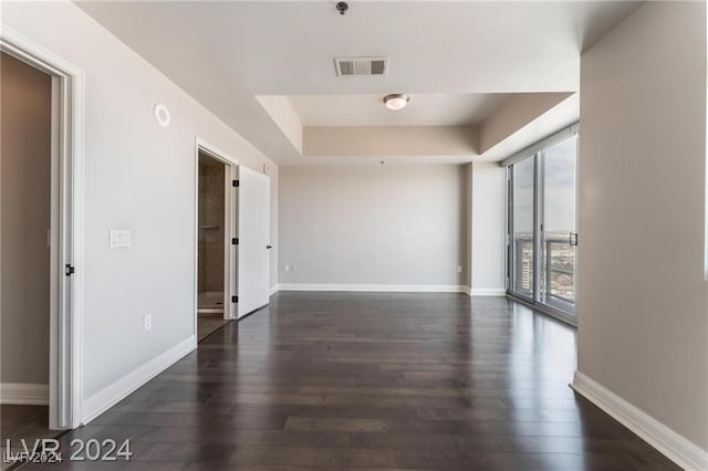 unfurnished room with dark hardwood / wood-style floors