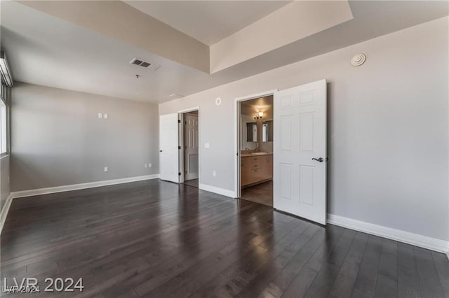 unfurnished room with dark wood-type flooring