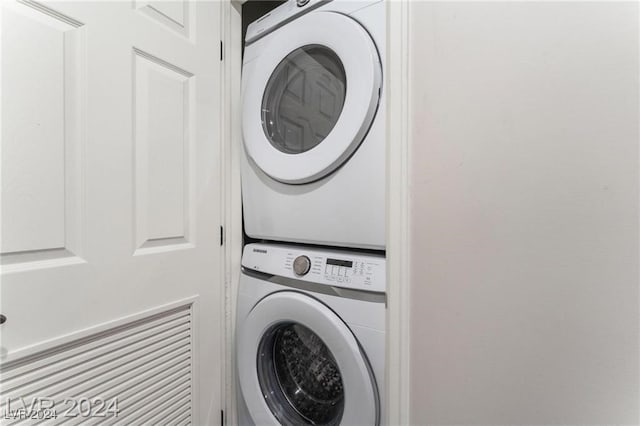 washroom featuring stacked washing maching and dryer