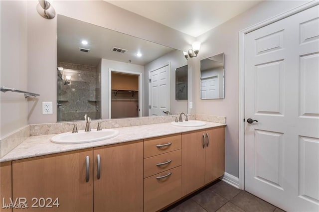 bathroom with vanity, tile patterned floors, and a shower with shower door