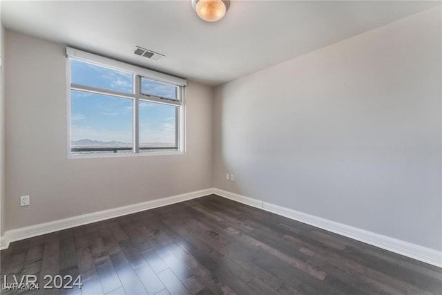 empty room featuring dark wood-type flooring