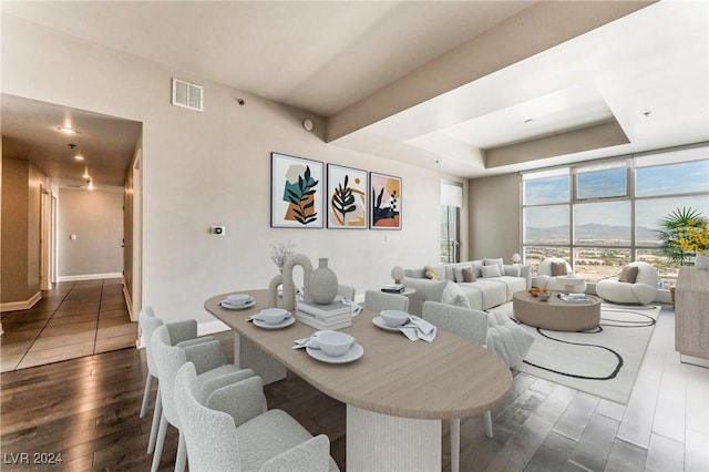 150 Las Vegas Blvd Unit 2512, Las Vegas, NV 89101 - dining area featuring wood finished floors, a raised ceiling, and floor to ceiling windows