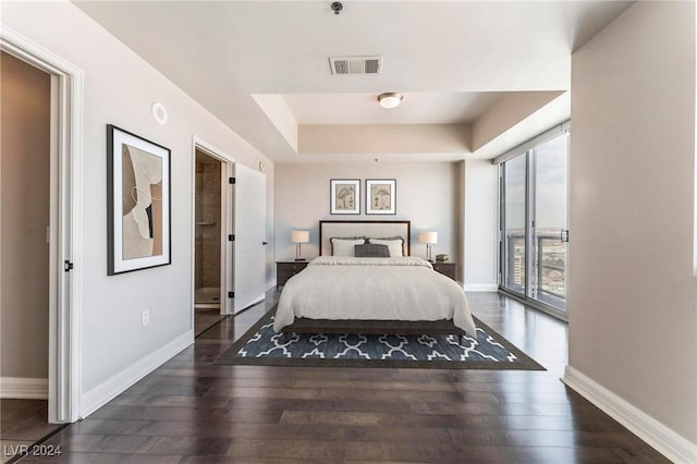 150 Las Vegas Blvd Unit 2512, Las Vegas, NV 89101 - bedroom featuring wood finished floors, a tray ceiling, and access to exterior