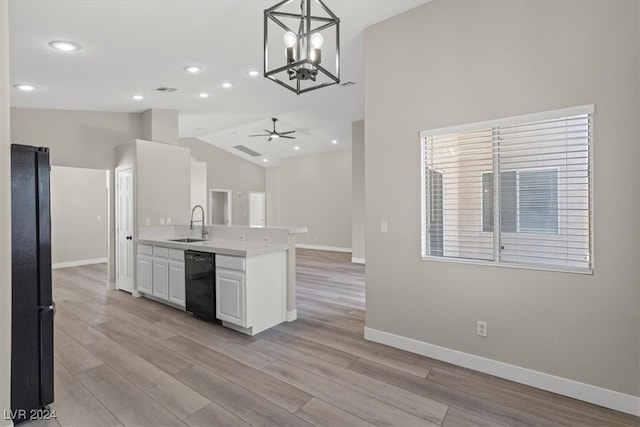 kitchen with black appliances, white cabinetry, hanging light fixtures, and light hardwood / wood-style flooring