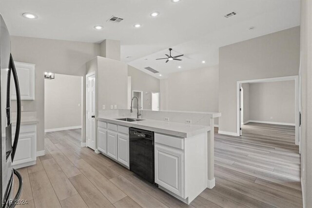 kitchen with white cabinetry, sink, stainless steel fridge, light wood-type flooring, and black dishwasher