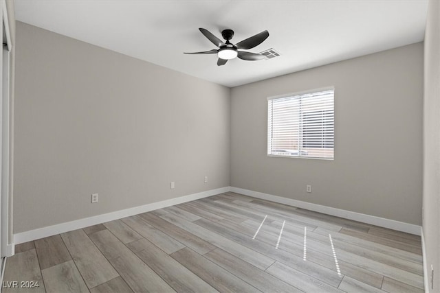 spare room featuring ceiling fan and light hardwood / wood-style flooring