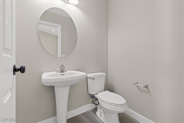 bathroom featuring hardwood / wood-style floors, sink, and toilet