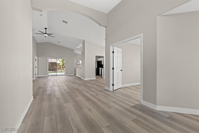 unfurnished living room featuring ceiling fan, light wood-type flooring, and high vaulted ceiling