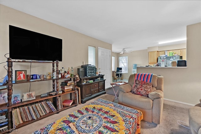 living room featuring ceiling fan and light colored carpet