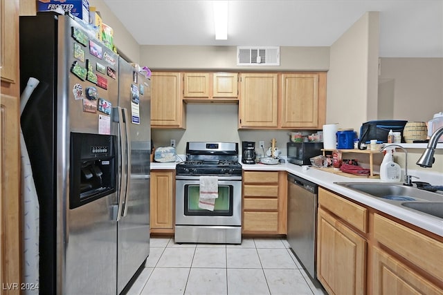 kitchen featuring light tile patterned flooring, light brown cabinets, sink, and stainless steel appliances