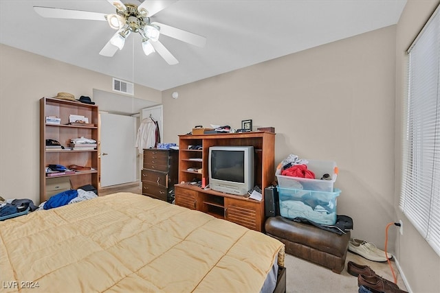 carpeted bedroom with ceiling fan and a closet