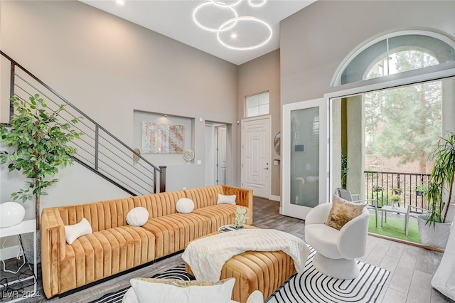 living room featuring hardwood / wood-style flooring and a towering ceiling