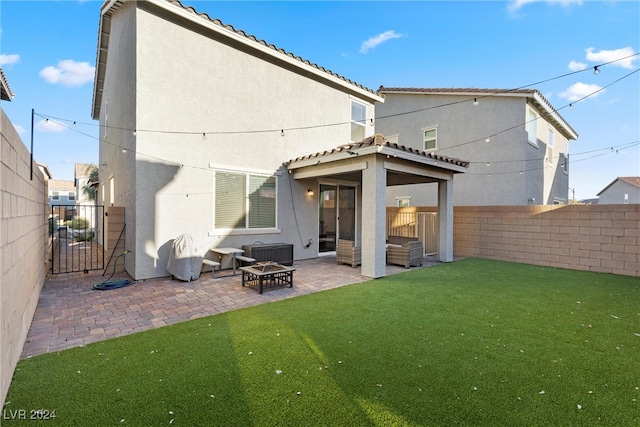 back of property featuring a lawn and a patio area