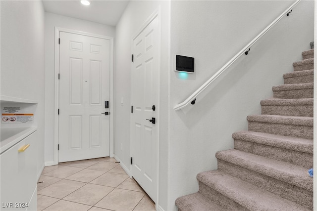 interior space featuring washer / clothes dryer and light tile patterned floors