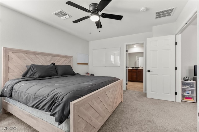 bedroom featuring connected bathroom, ceiling fan, and light colored carpet